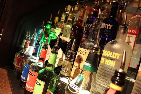 Liquor bottles on a lighted bar shelf
